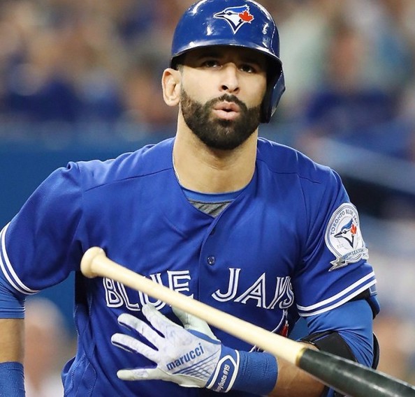 Former Toronto Blue Jays player Jose Bautista wipes a tear as he and his  family look on as his name is unveiled on the Jays' Level of Excellence,  ahead of their baseball